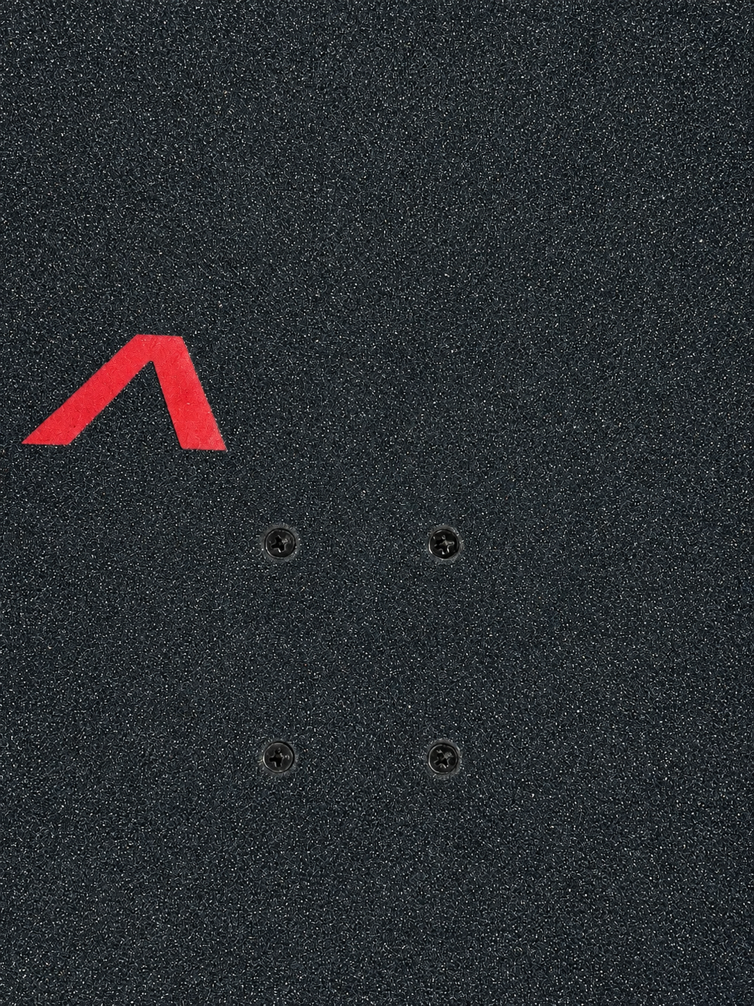 Close-up of premium perforated black grip tape with the custom die-cut Asinine "A" logo and skateboard truck mounting holes.